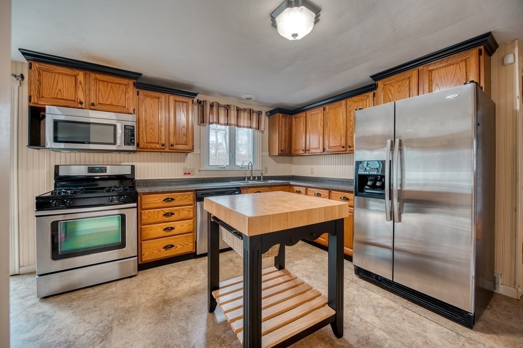 150 Louis Road Springfield, MA 01118 - Photo 3 of 39 a kitchen with stainless steel appliances granite countertop a refrigerator a stove top oven a sink and dishwasher