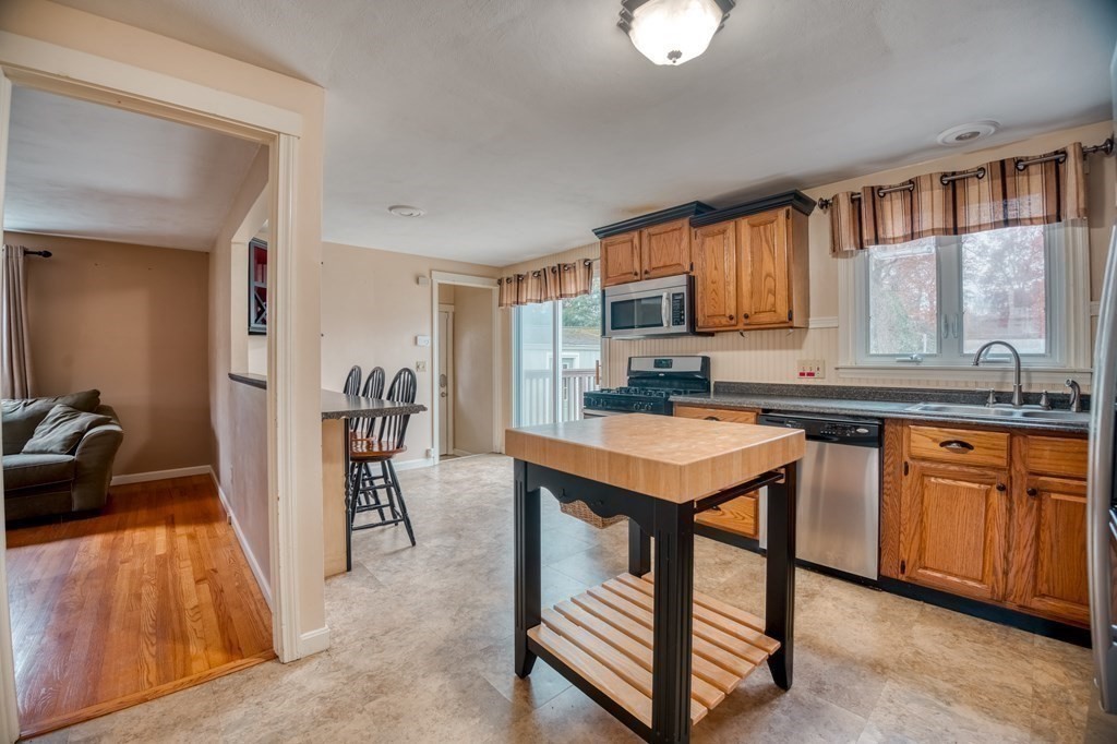150 Louis Road Springfield, MA 01118 - Photo 9 of 39 a kitchen with stainless steel appliances granite countertop a stove top oven a sink dishwasher and cabinets with wooden floor