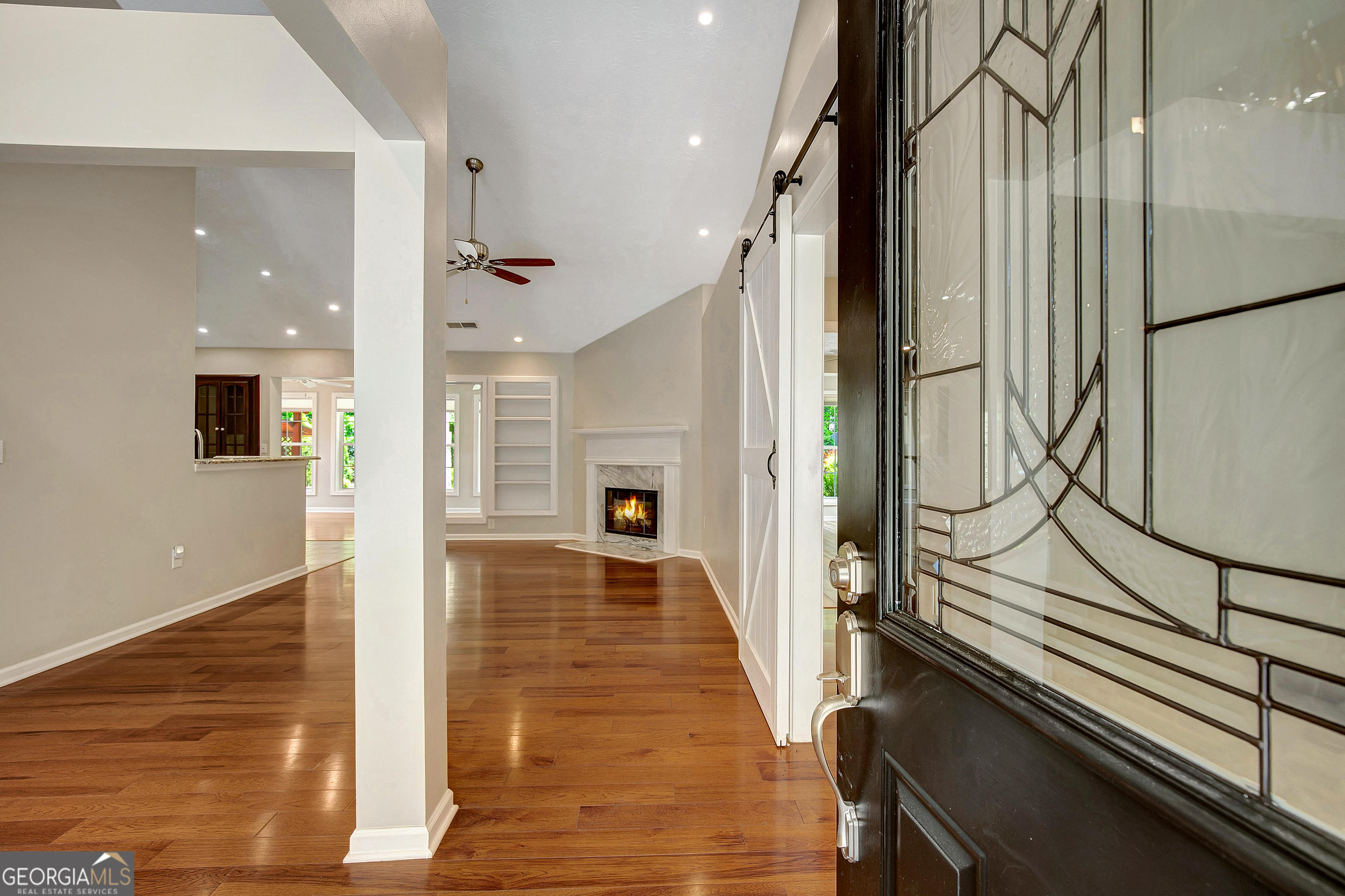 128 Lake Cove Approach Newnan, GA 30265 - Photo 12 of 63 a view of a hallway with wooden floor and staircase