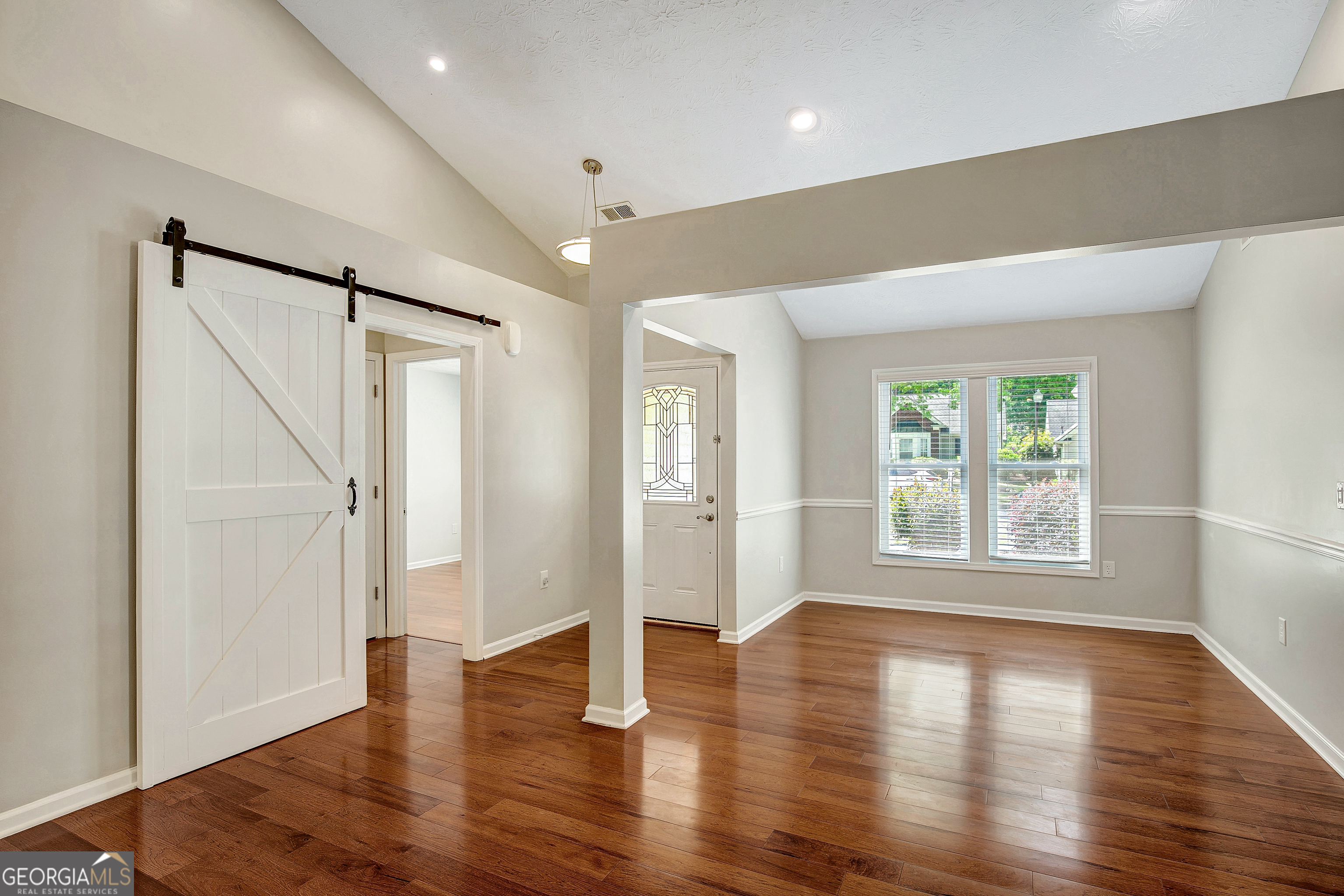 128 Lake Cove Approach Newnan, GA 30265 - Photo 16 of 63 an empty room with wooden floor and windows
