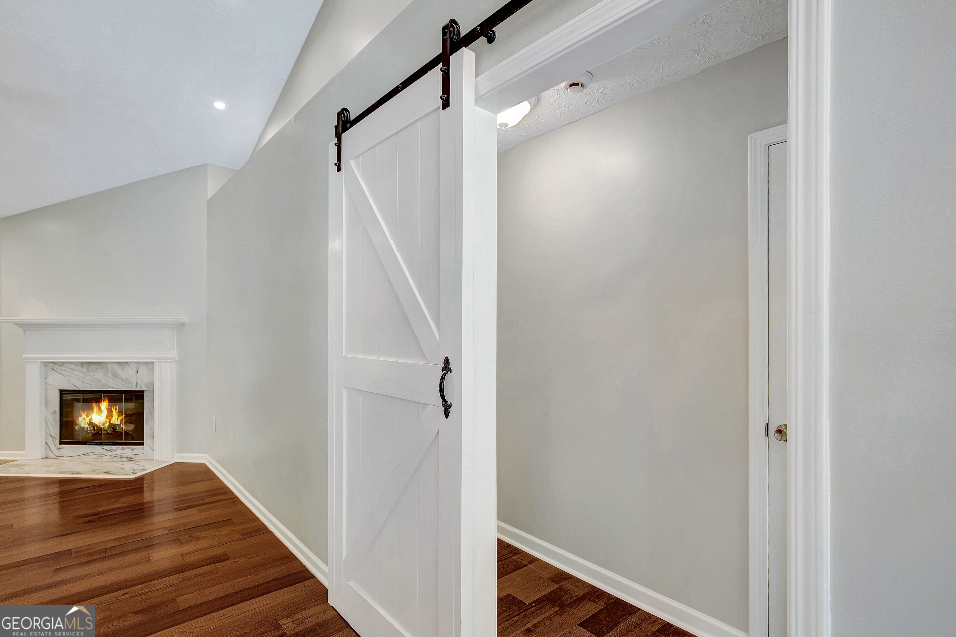 128 Lake Cove Approach Newnan, GA 30265 - Photo 19 of 63 a view of a hallway with wooden floor and staircase