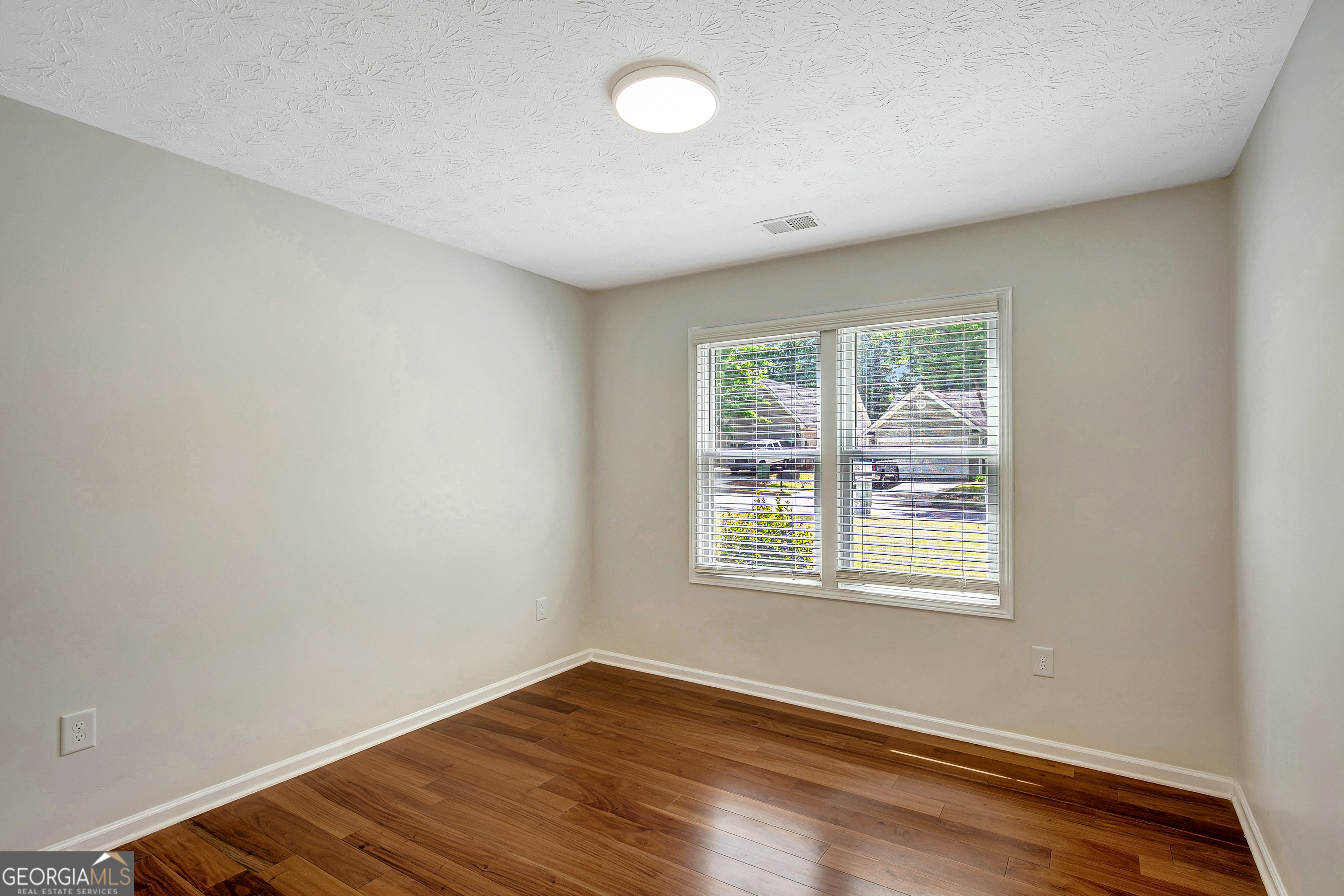 128 Lake Cove Approach Newnan, GA 30265 - Photo 20 of 63 an empty room with wooden floor and windows