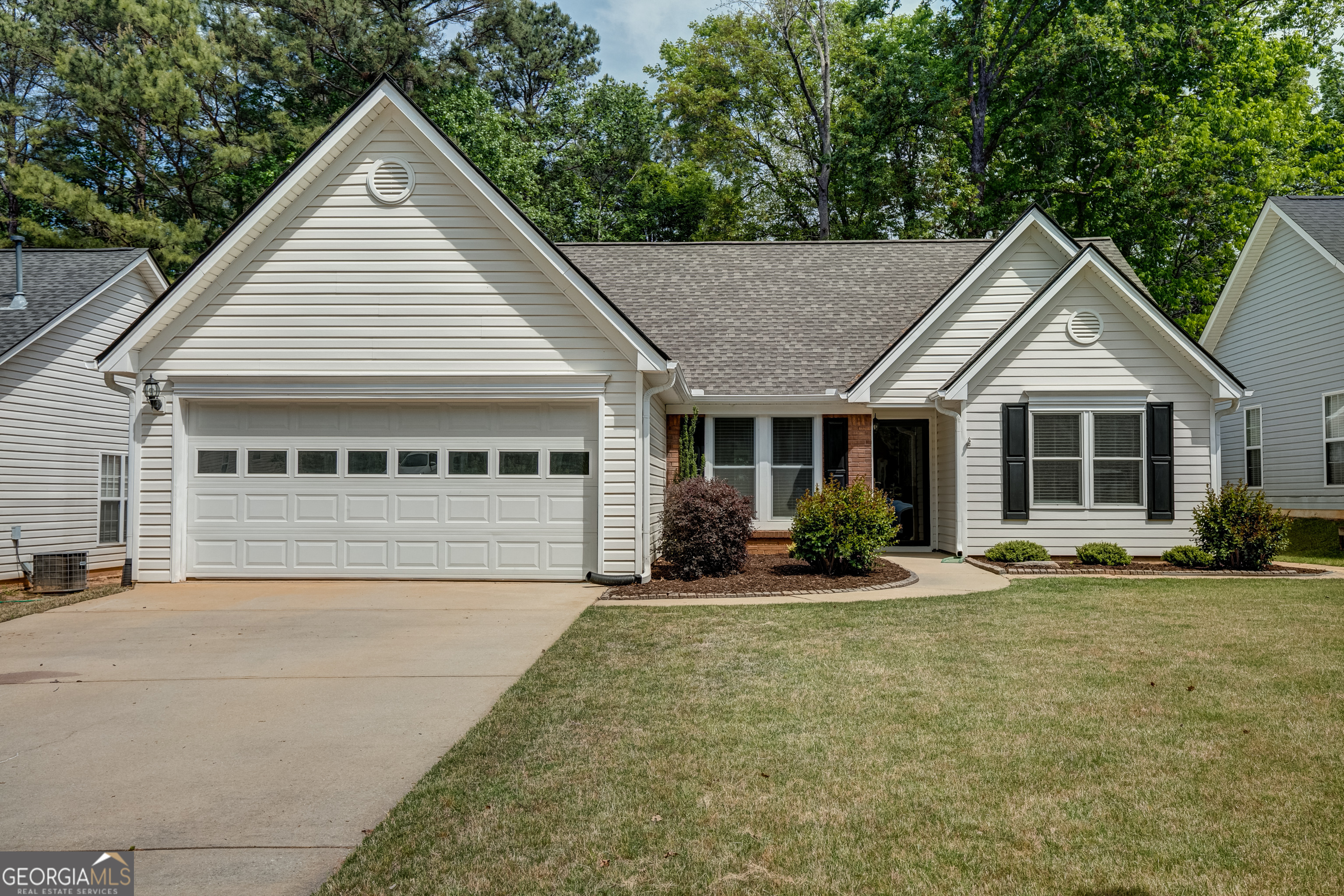 128 Lake Cove Approach Newnan, GA 30265 - Photo 2 of 63 a front view of a house with a yard and porch