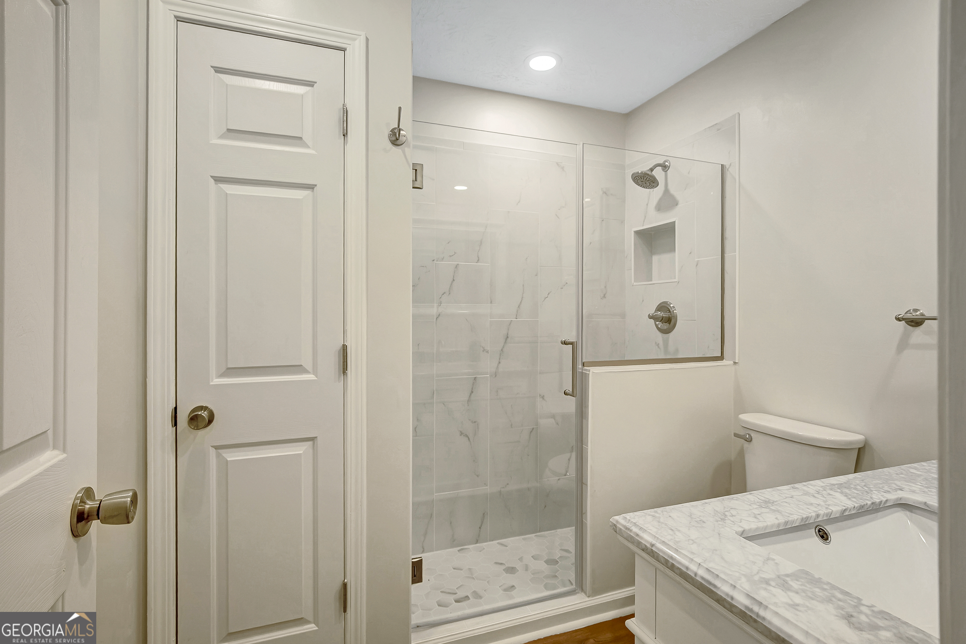 128 Lake Cove Approach Newnan, GA 30265 - Photo 22 of 63 a bathroom with a granite countertop sink a toilet and shower