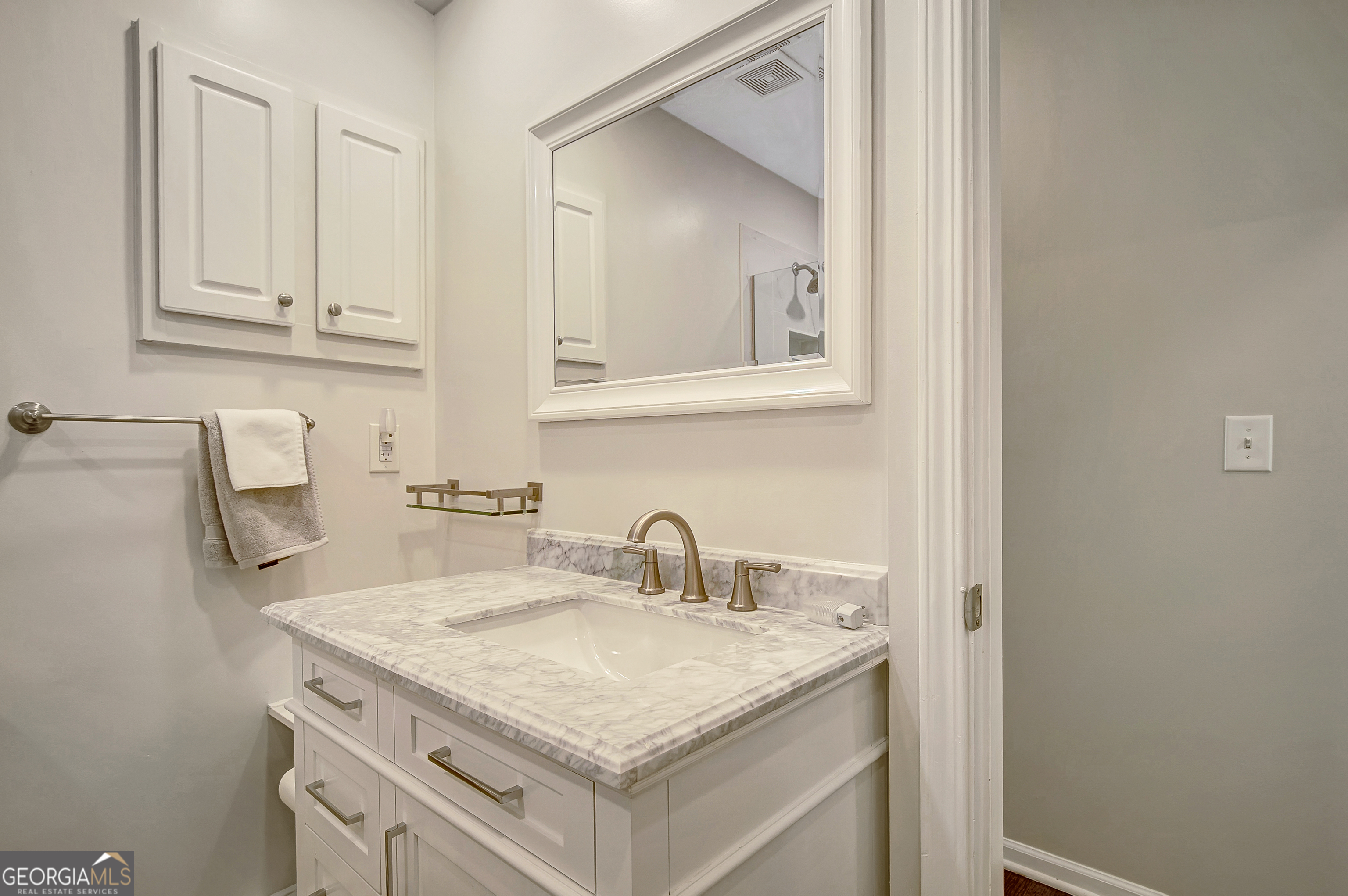 128 Lake Cove Approach Newnan, GA 30265 - Photo 23 of 63 a bathroom with a granite countertop sink and a mirror