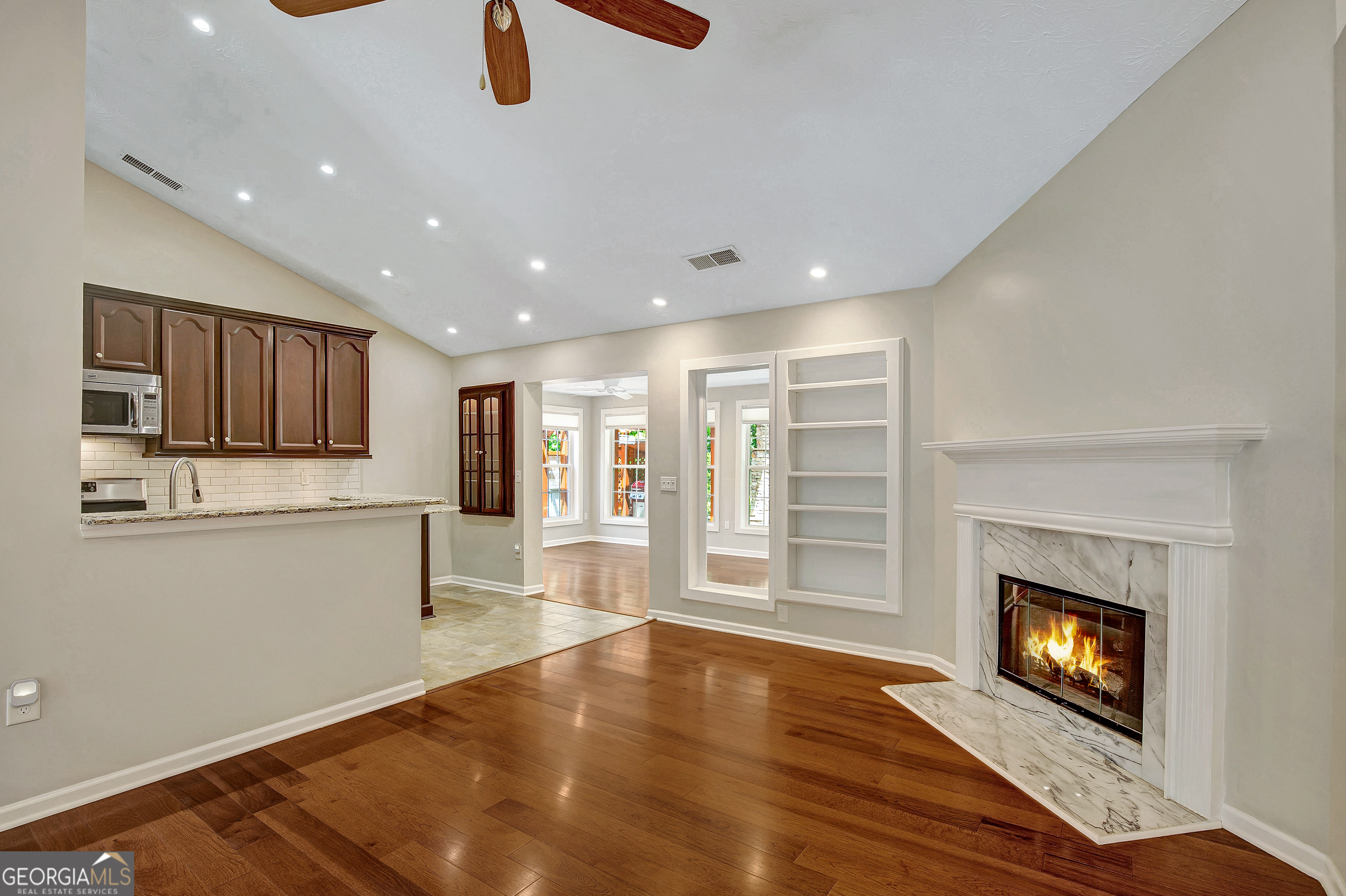 128 Lake Cove Approach Newnan, GA 30265 - Photo 28 of 63 a view of a kitchen with an empty space and a fireplace