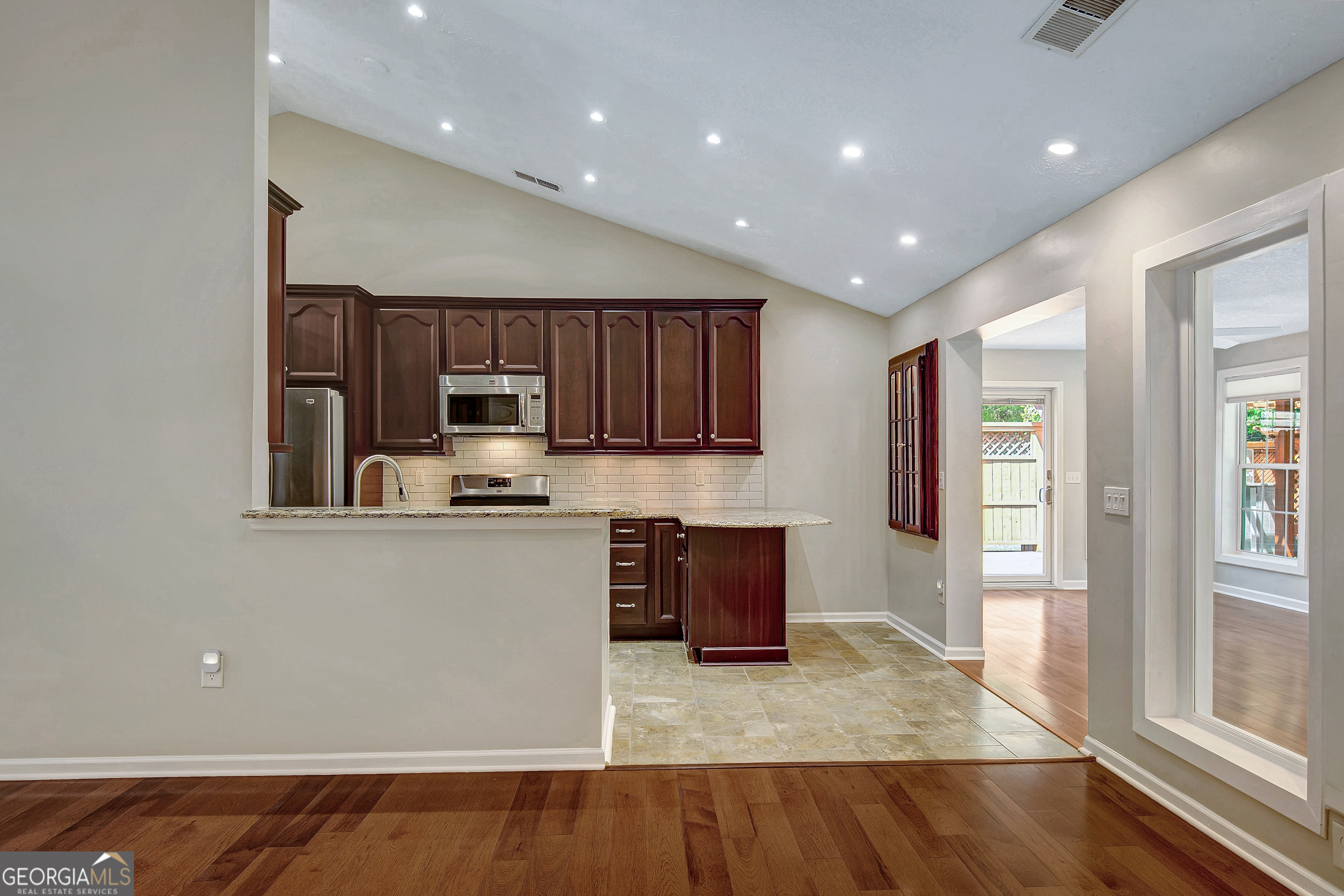 128 Lake Cove Approach Newnan, GA 30265 - Photo 29 of 63 a kitchen with stainless steel appliances granite countertop a refrigerator and a stove top oven