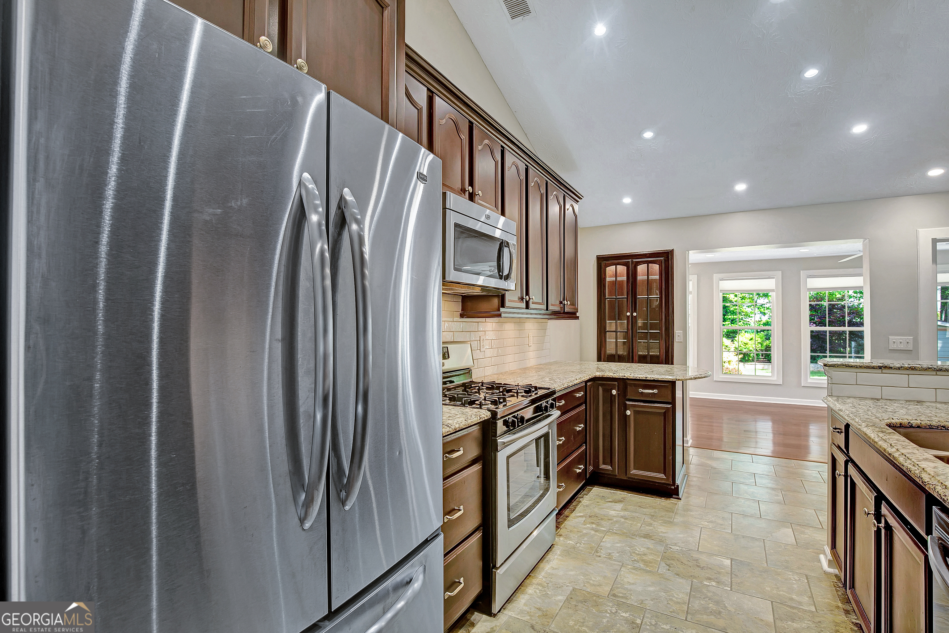 128 Lake Cove Approach Newnan, GA 30265 - Photo 36 of 63 a kitchen with stainless steel appliances granite countertop a refrigerator a stove and a sink