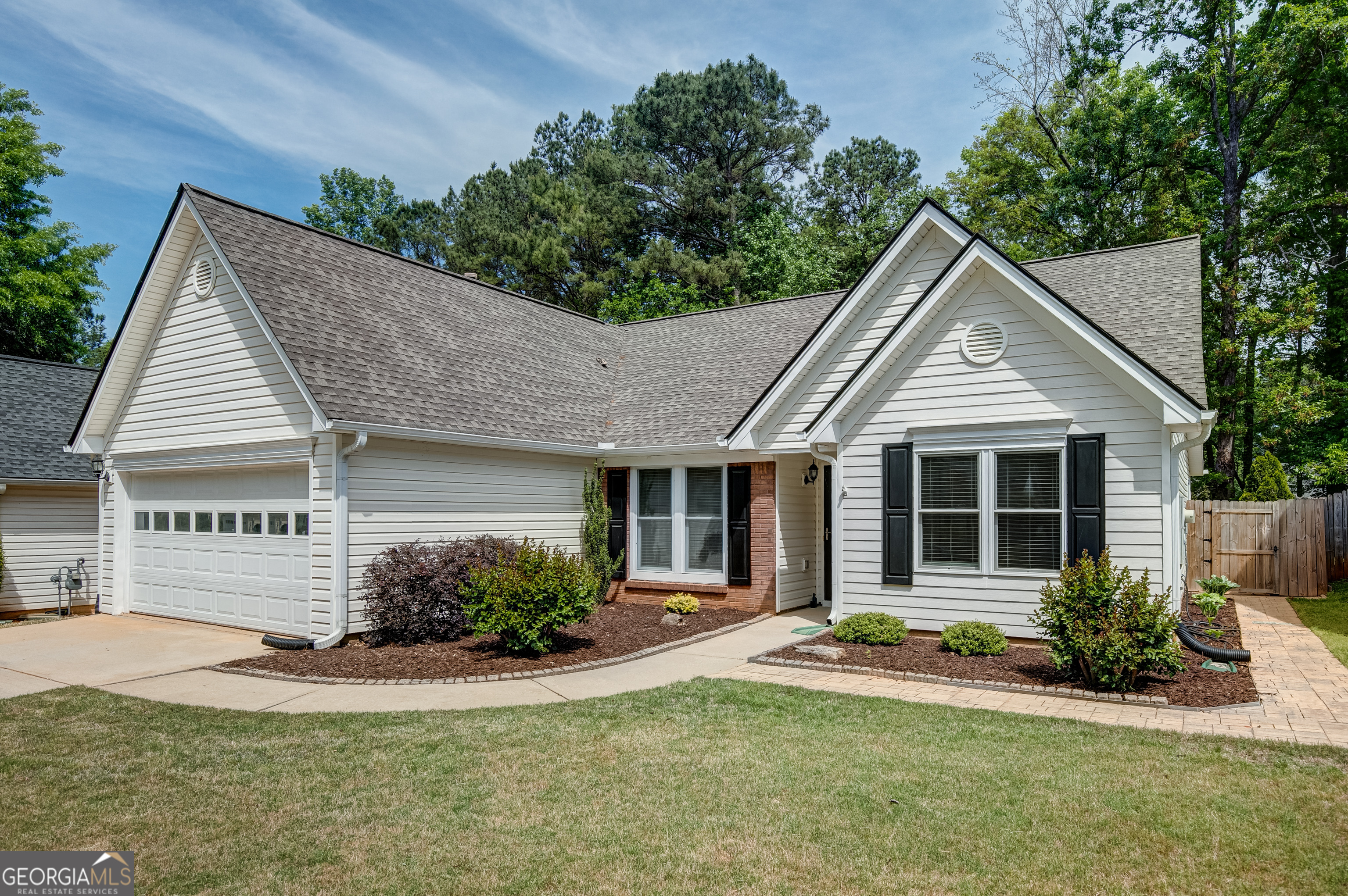 128 Lake Cove Approach Newnan, GA 30265 - Photo 4 of 63 a view of a white house next to a yard and palm trees