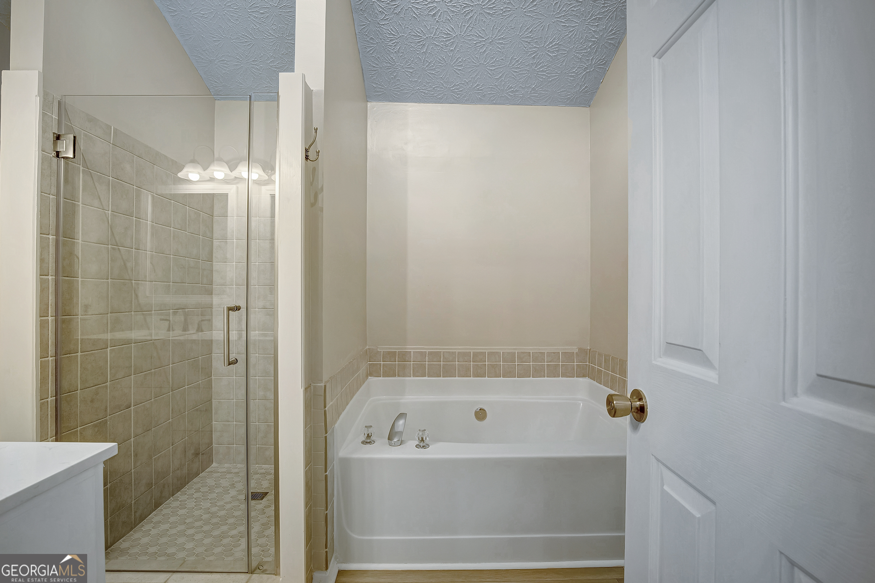 128 Lake Cove Approach Newnan, GA 30265 - Photo 42 of 63 a bathroom with a bathtub and shower