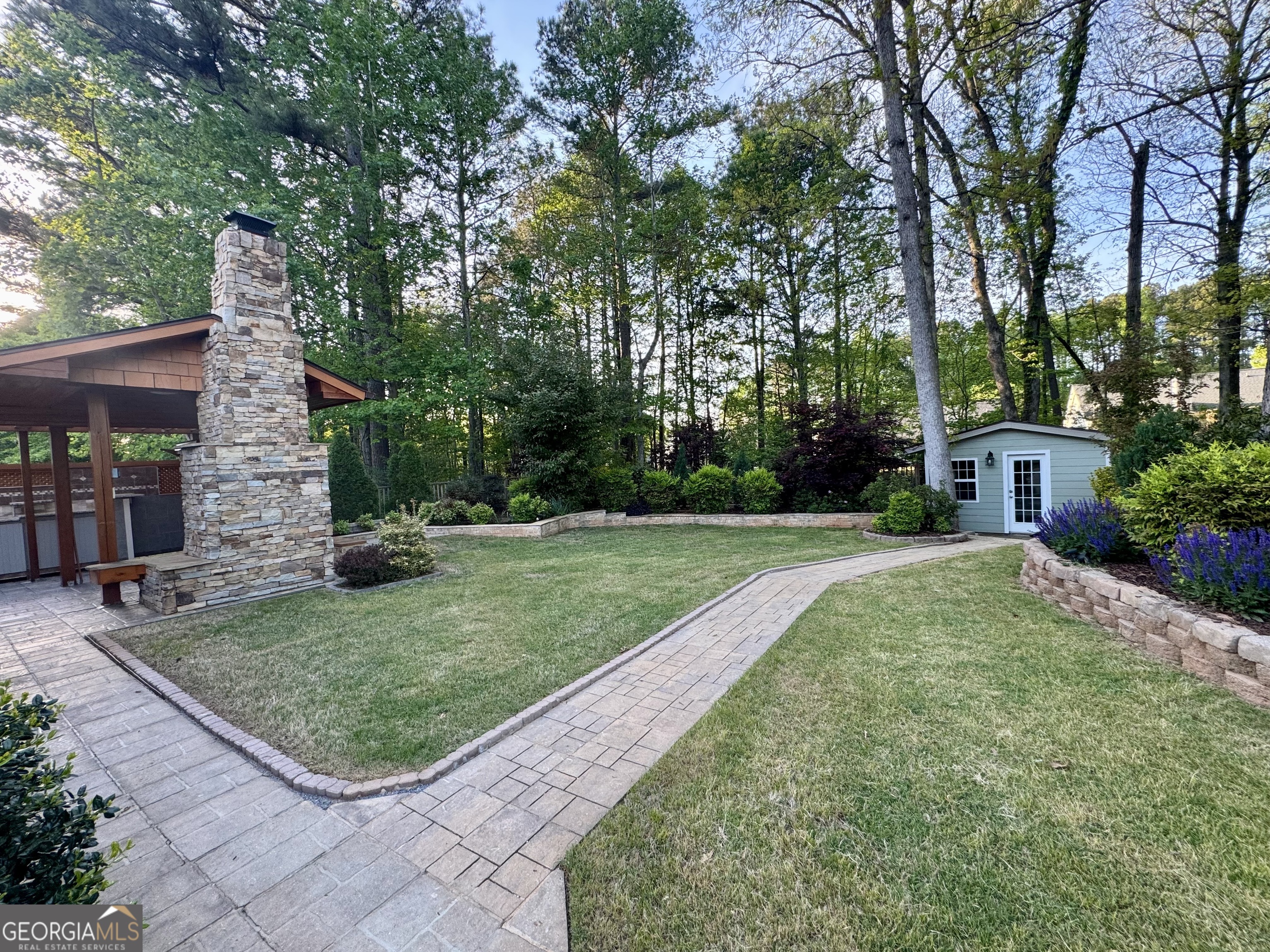 128 Lake Cove Approach Newnan, GA 30265 - Photo 5 of 63 a view of a backyard with a garden and trees