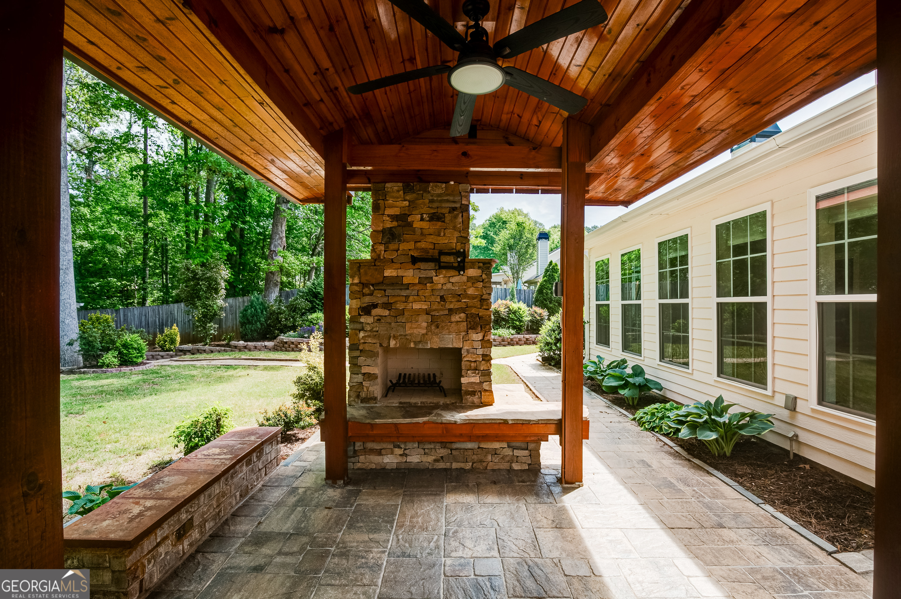 128 Lake Cove Approach Newnan, GA 30265 - Photo 51 of 63 a porch with a table and chairs next to a yard