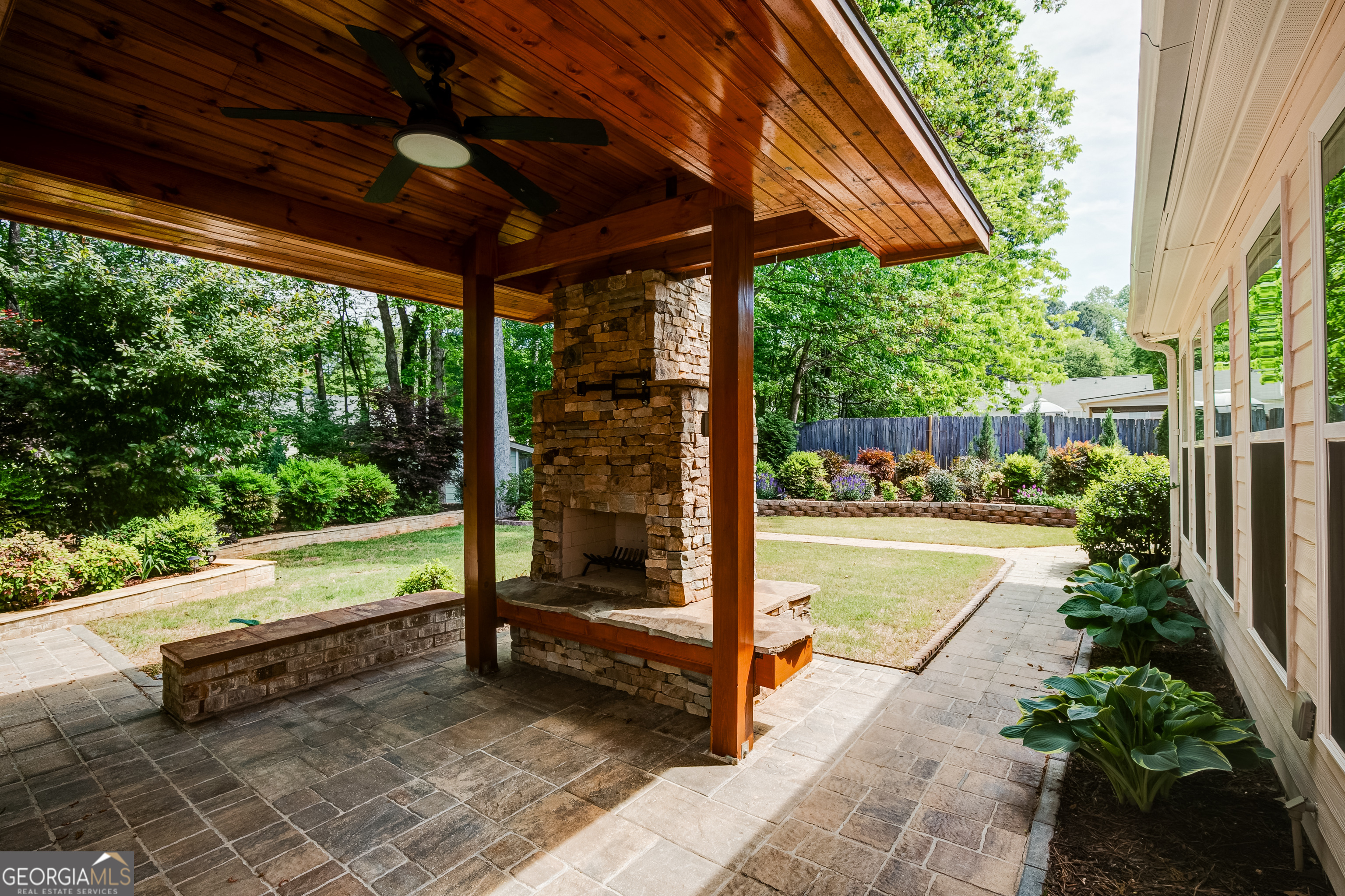 128 Lake Cove Approach Newnan, GA 30265 - Photo 52 of 63 a view of porch with a table and chairs under an umbrella with a large tree