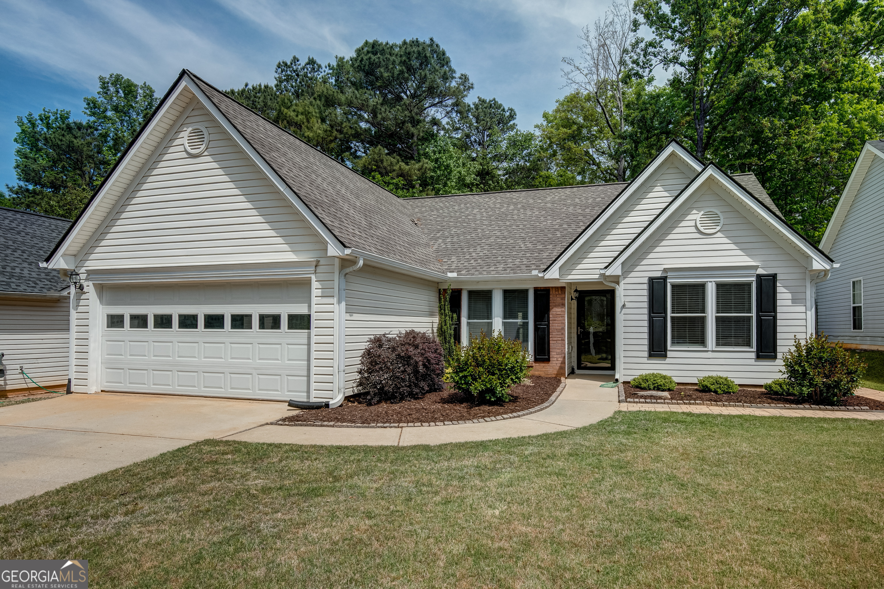 128 Lake Cove Approach Newnan, GA 30265 - Photo 6 of 63 a view of a house with sitting area and garden