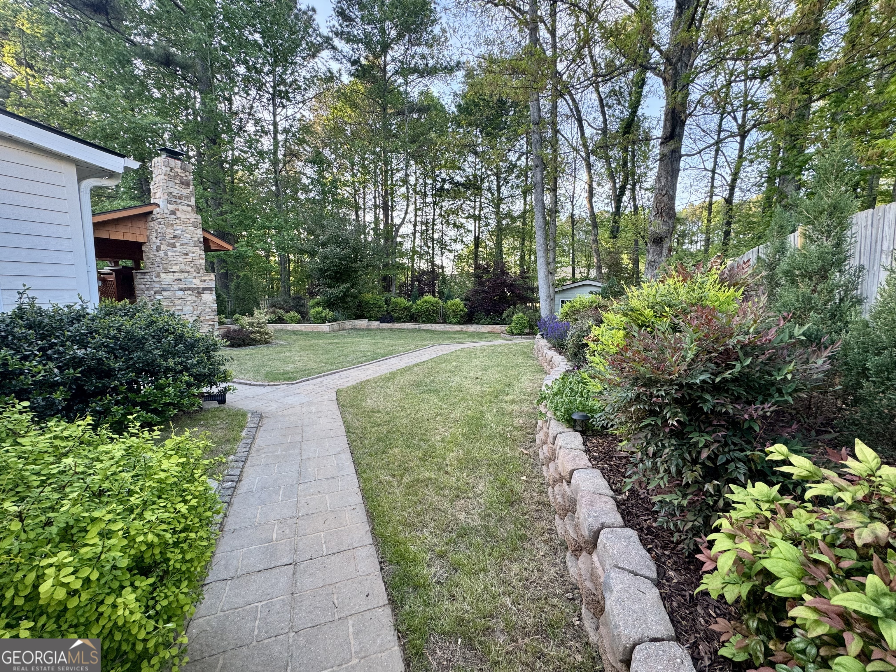128 Lake Cove Approach Newnan, GA 30265 - Photo 7 of 63 a view of a back yard with flower plants
