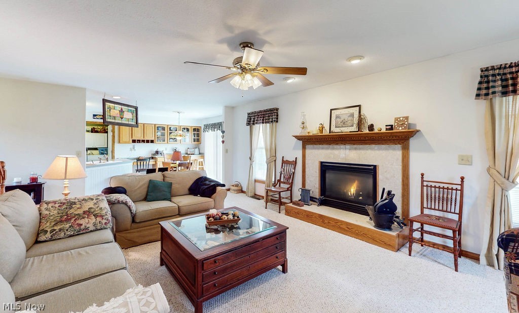 10147 Page Road Streetsboro, OH 44241 - Photo 13 of 35 Living room featuring light colored carpet, ceiling fan, and a fireplace