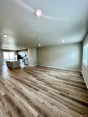 a view of kitchen and empty room