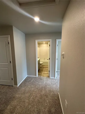 an empty room with closet and wooden floor