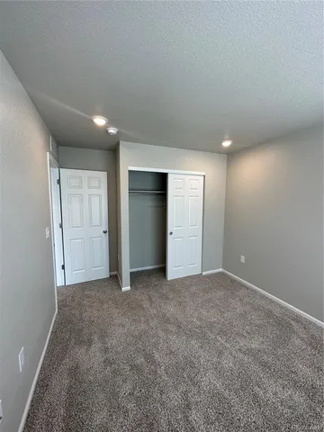 an empty room with closet and bathroom