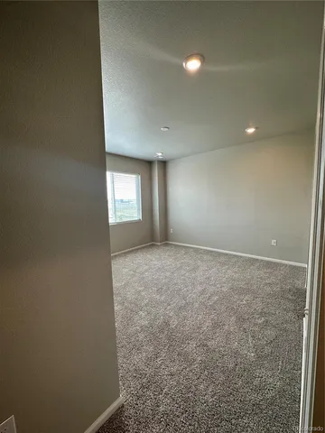 an empty room with window and pillar in it