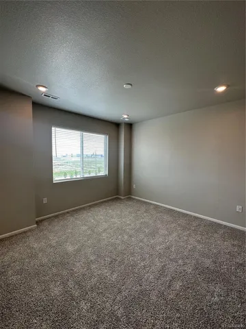 a view of an empty room and a window