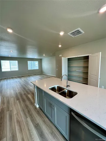 a kitchen with kitchen island a sink and a stove