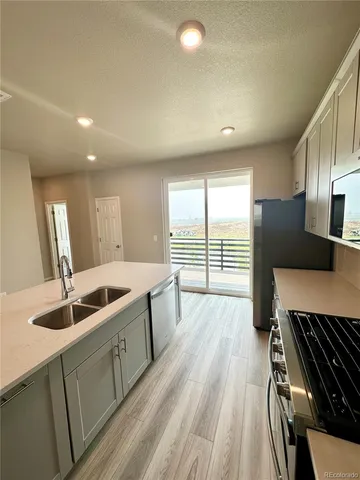 a kitchen with sink and refrigerator