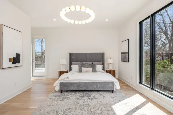 a bedroom with a bed and a large window