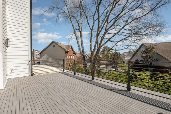 a view of a street with wooden fence
