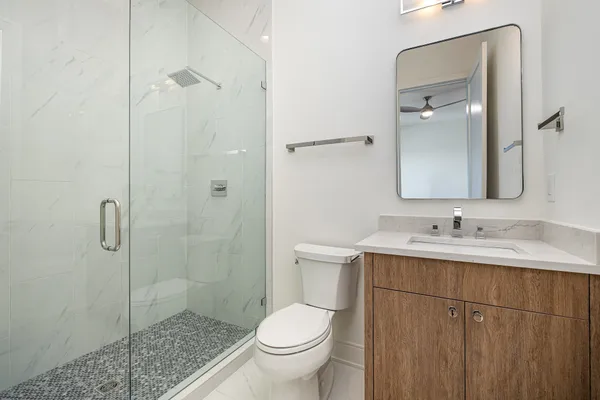 a bathroom with a toilet sink and shower