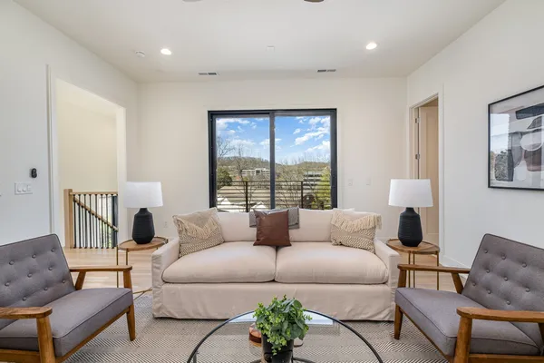 a living room with furniture and a large window