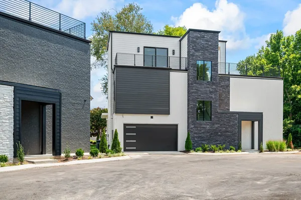 front view of a brick house with a street