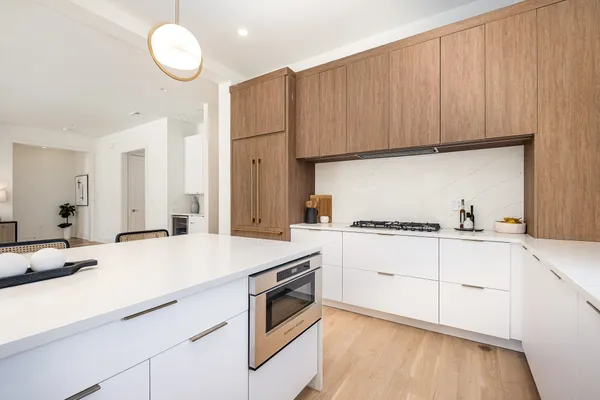 a kitchen with granite countertop a white stove top oven and cabinets