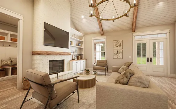 a living room with furniture a flat screen tv and a fireplace