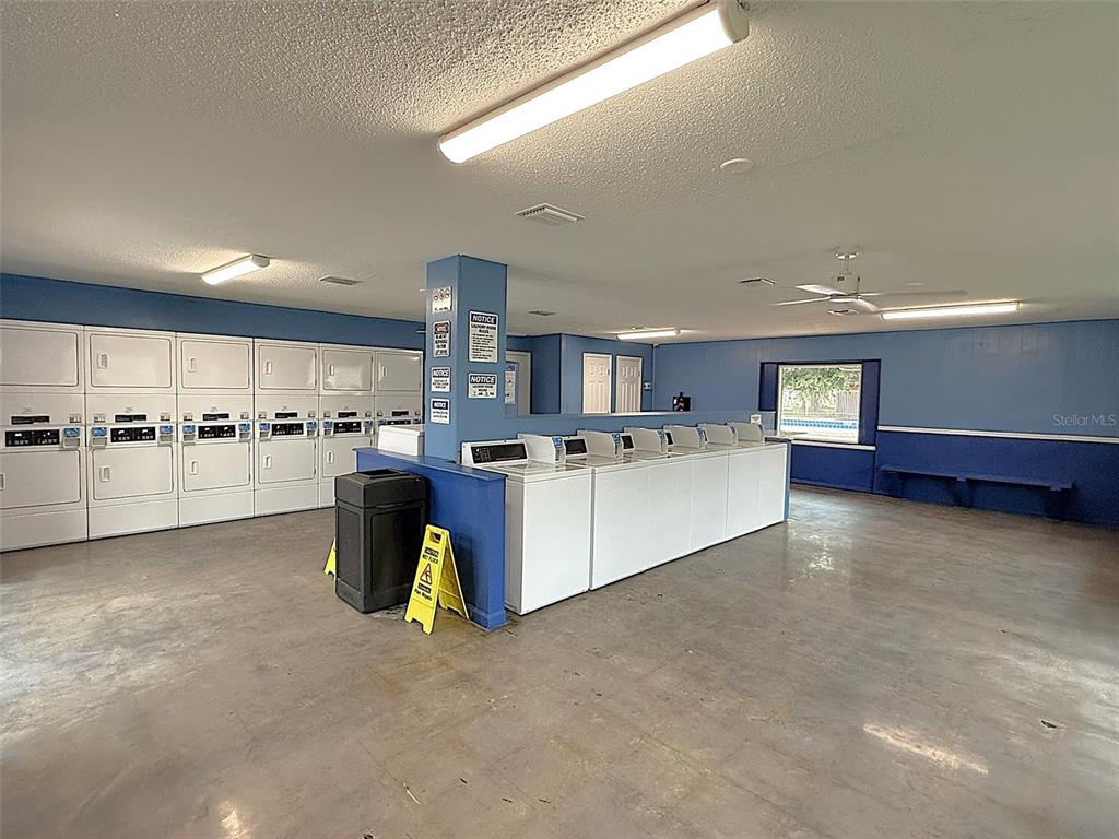 716 Michigan Court, Unit 2 St. Cloud, FL 34769 - Photo 16 of 17 a large white kitchen with lots of counter space white cabinets and stainless steel appliances