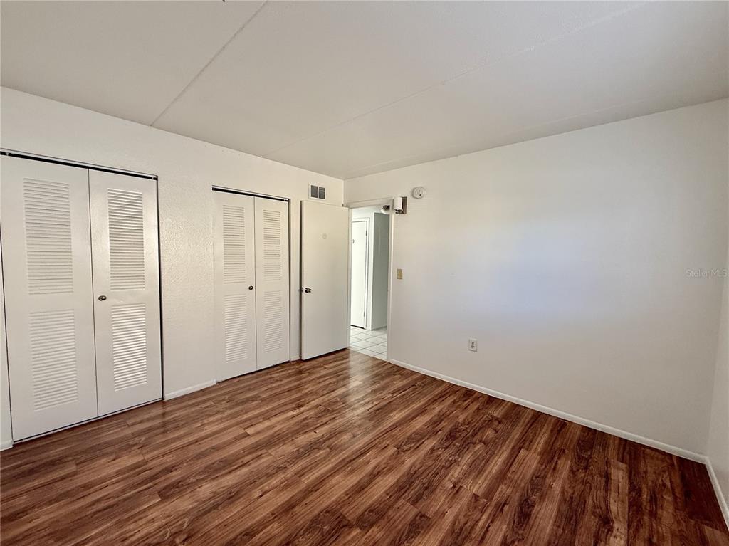 716 Michigan Court, Unit 2 St. Cloud, FL 34769 - Photo 9 of 17 a view of an empty room with wooden floor