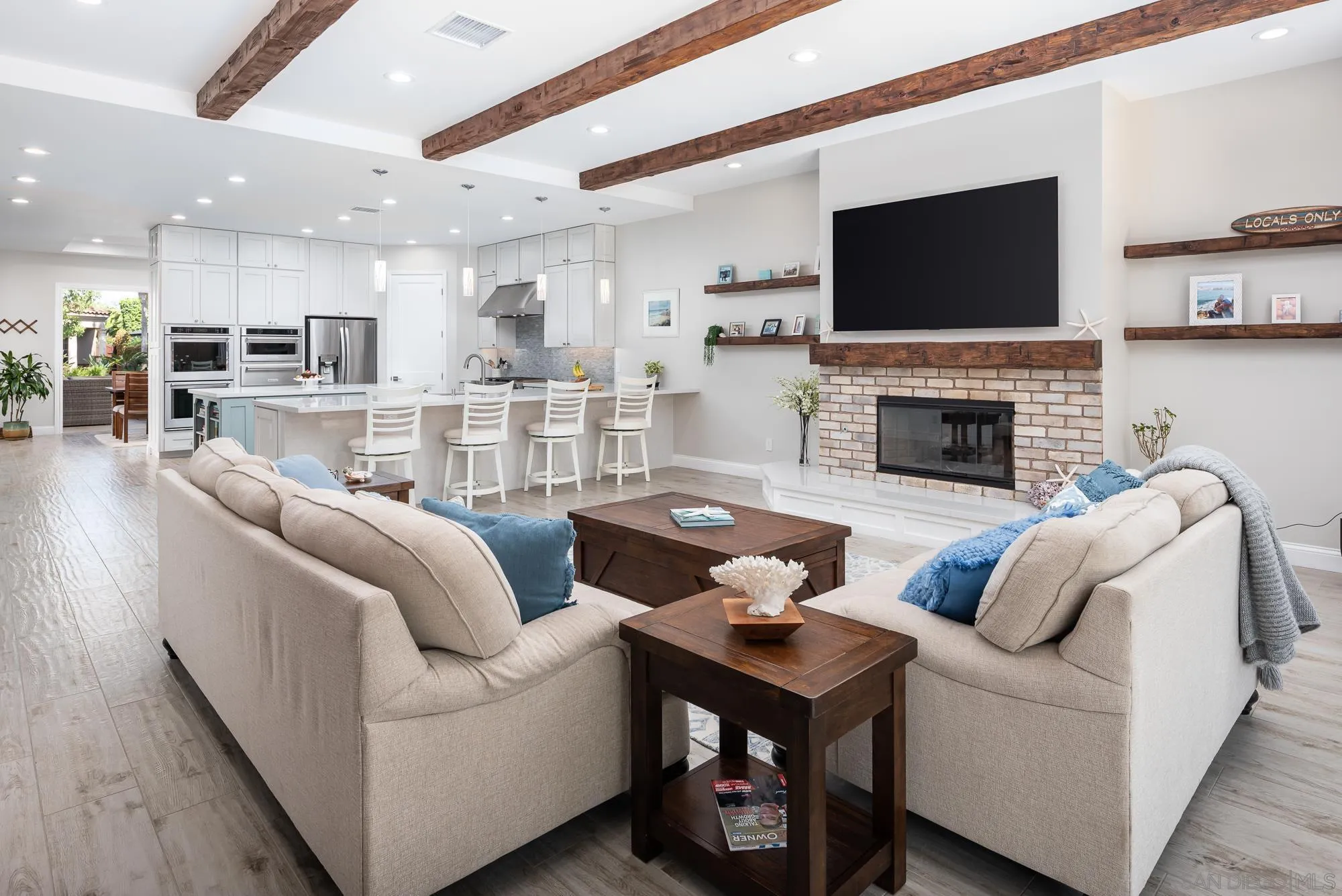 1060 Pine Street Coronado, CA 92118 - Photo 12 of 36 a living room with furniture a fireplace and a flat screen tv
