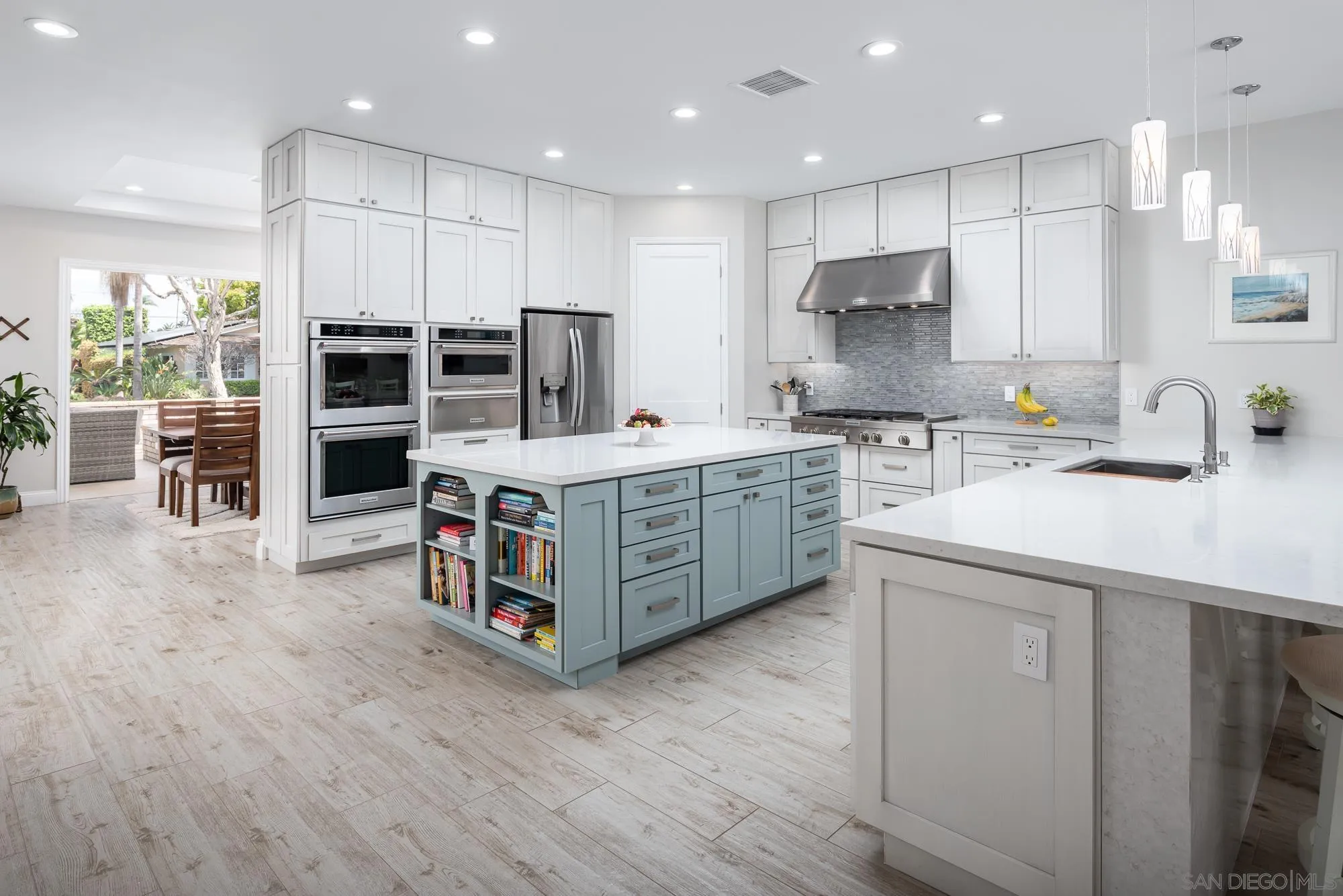 1060 Pine Street Coronado, CA 92118 - Photo 15 of 36 a kitchen with kitchen island granite countertop a sink and a stove top oven