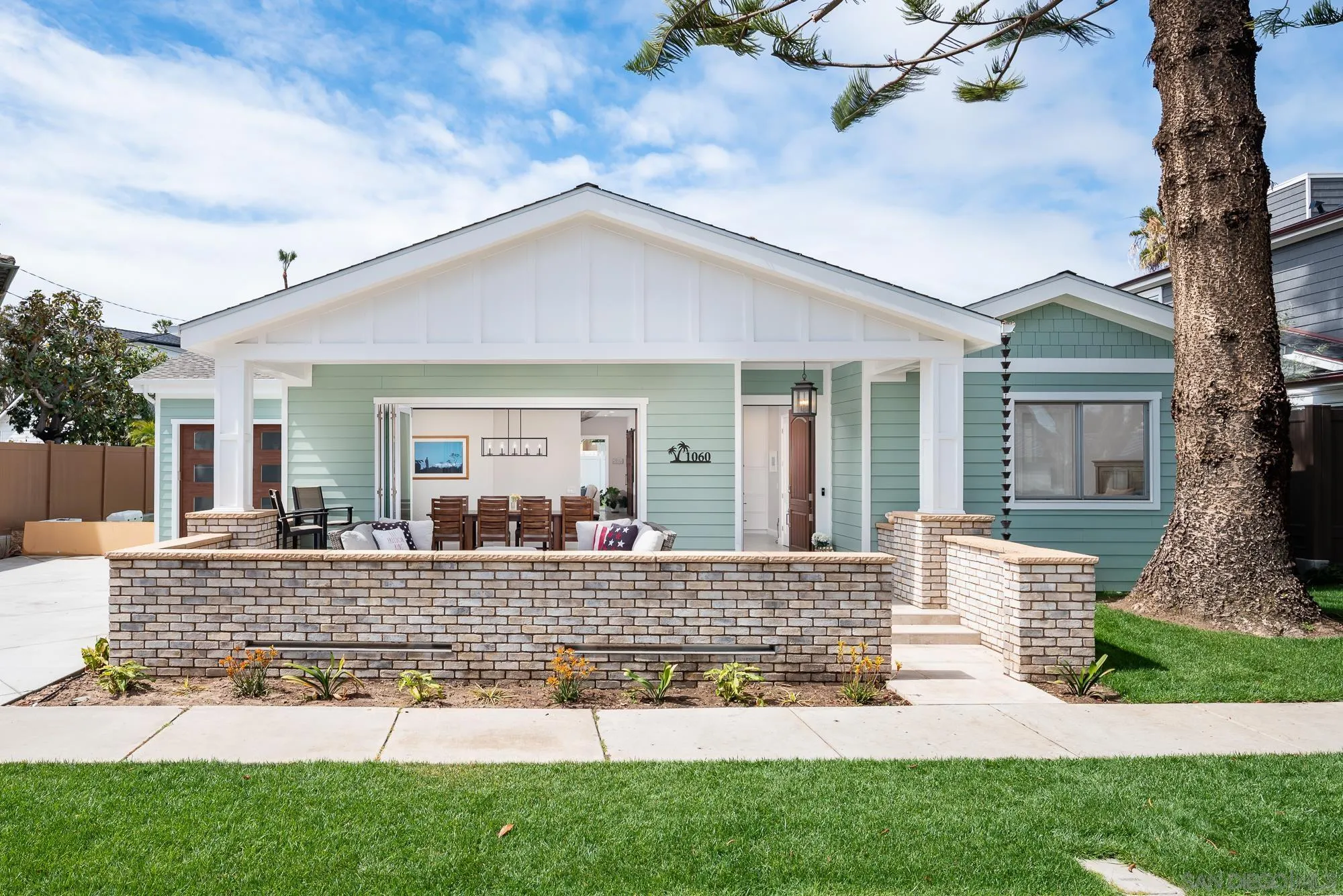 1060 Pine Street Coronado, CA 92118 - Photo 2 of 36 a front view of a house with porch and garden