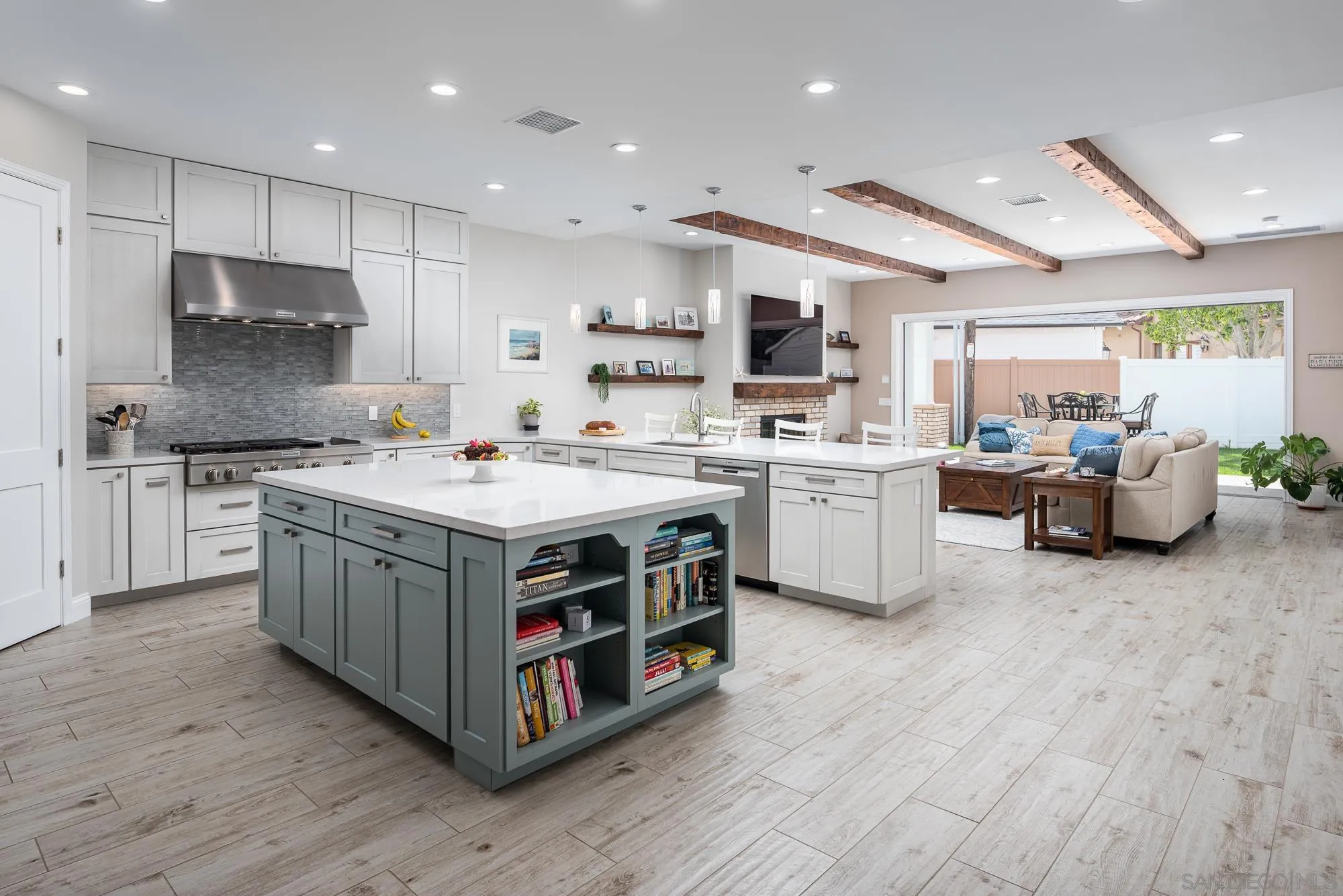 1060 Pine Street Coronado, CA 92118 - Photo 9 of 36 a kitchen with stainless steel appliances granite countertop a stove top oven a sink dishwasher and a refrigerator with wooden floor