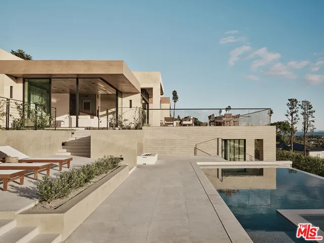 a view of a house with swimming pool and sitting area