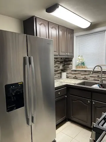 a bathroom with a granite countertop toilet sink and mirror