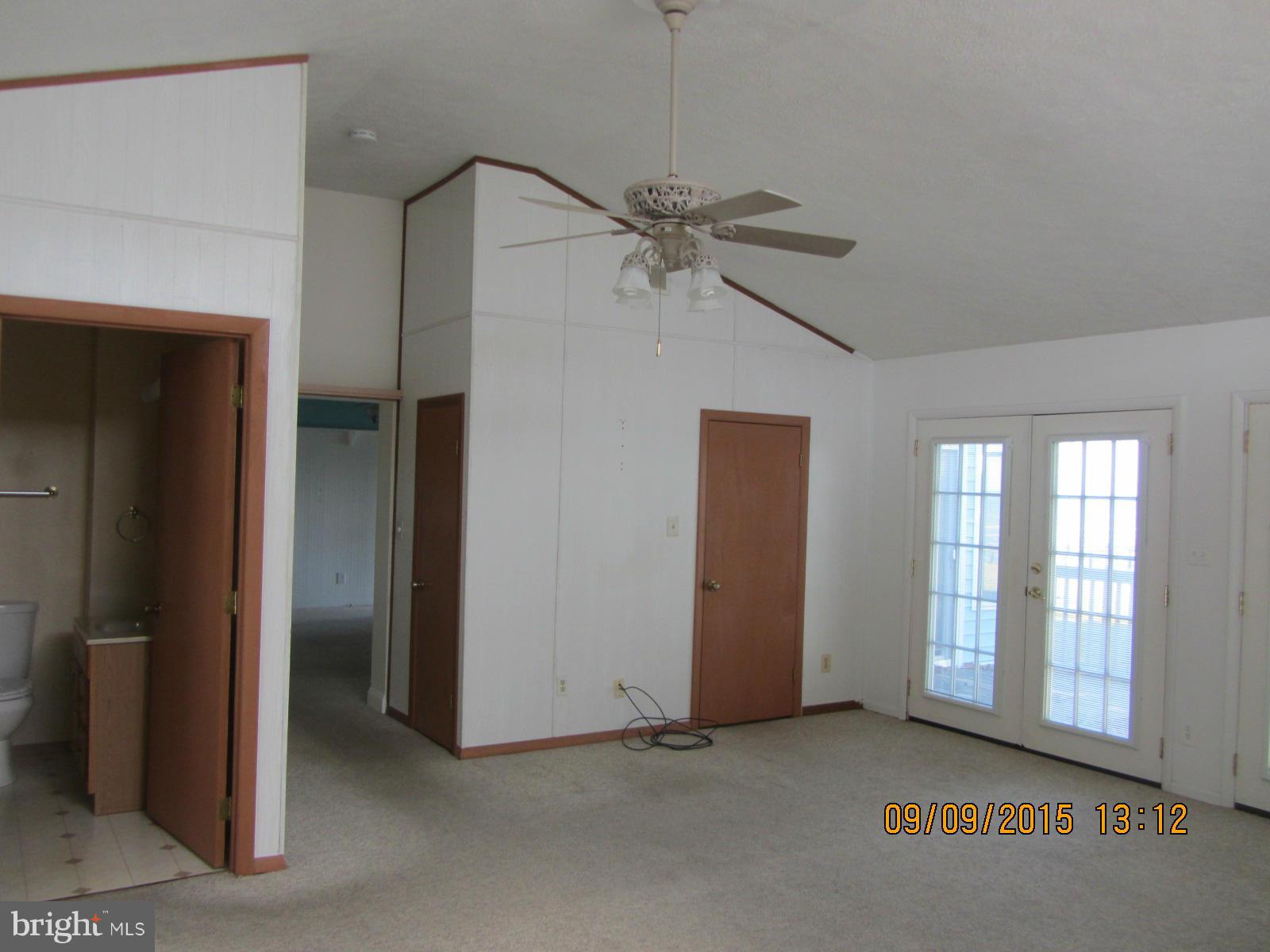 38451 Bayview Road Coltons Point, MD 20626 - Photo 11 of 30 an empty room with chandelier fan