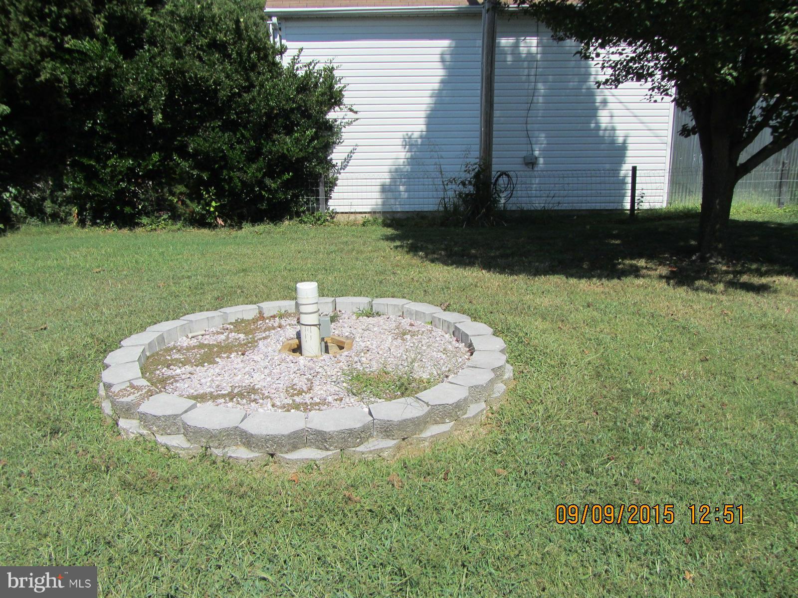 38451 Bayview Road Coltons Point, MD 20626 - Photo 28 of 30 a white house with a yard and outdoor seating