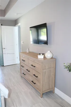 a bedroom with a bed and a dresser