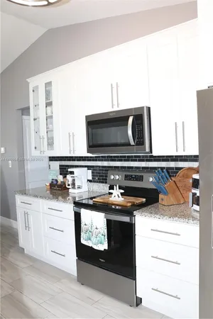 a kitchen with a stove and a microwave