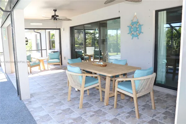 a view of a dining room with furniture wooden floor and a chandelier