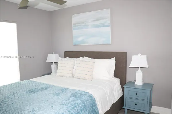 a bedroom with a bed and a lamp