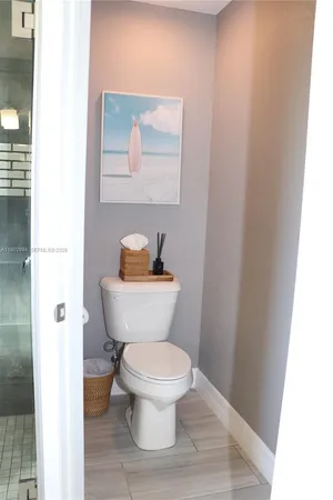a white toilet sitting next to a bathroom sink