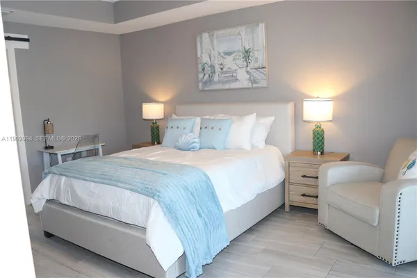 a bedroom with a bed and a lamp on table